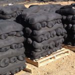 Pallets of filled GroSoxx units on a job site