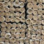 Rolls of erosion control blanket stacked on end