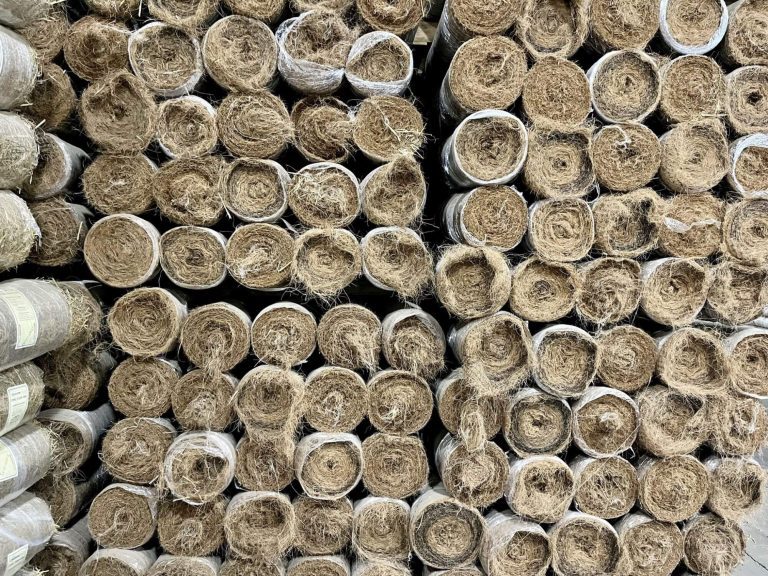 Rolls of erosion control blanket stacked on end
