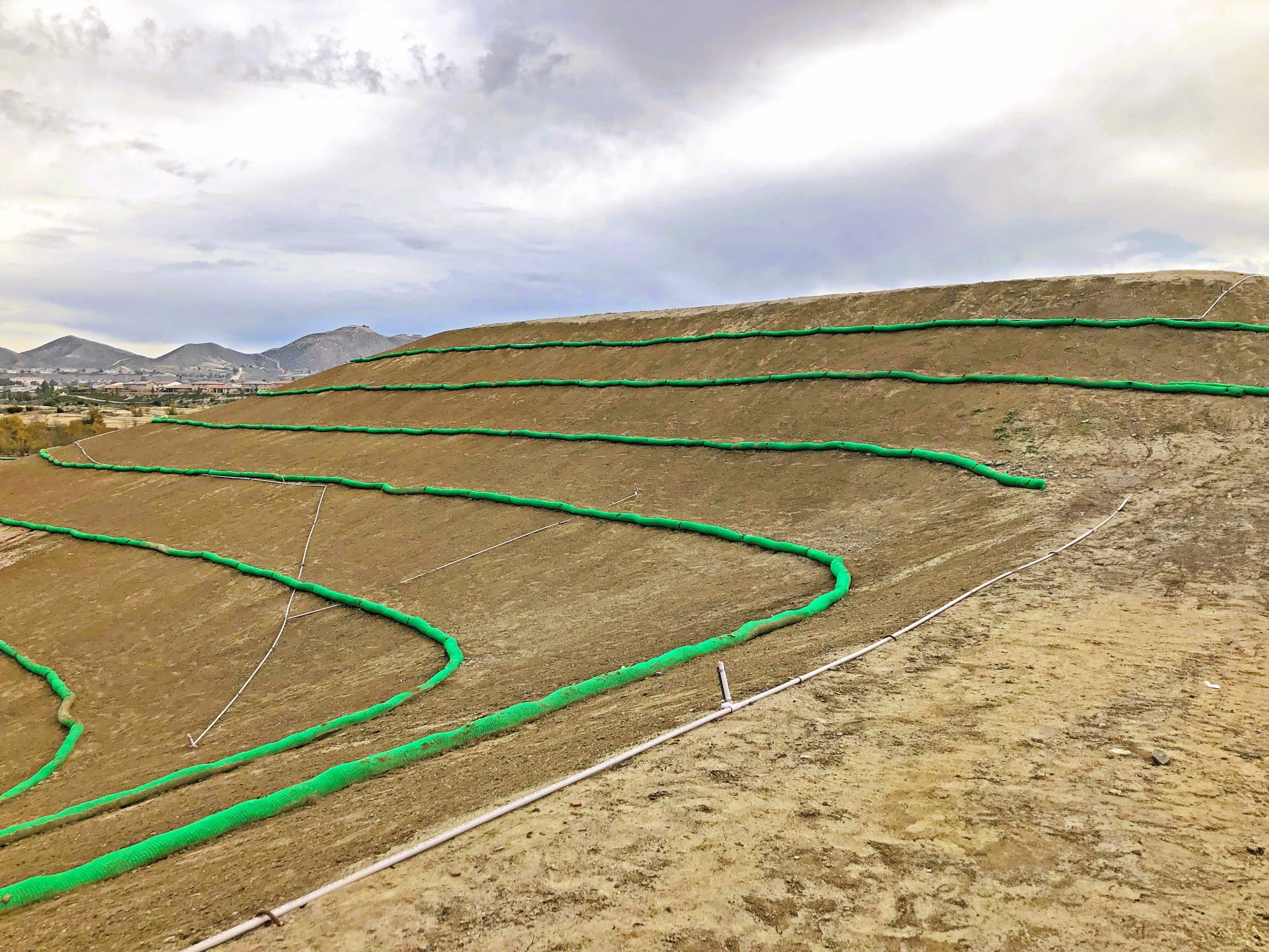 Sediment control products installed along a construction site perimeter