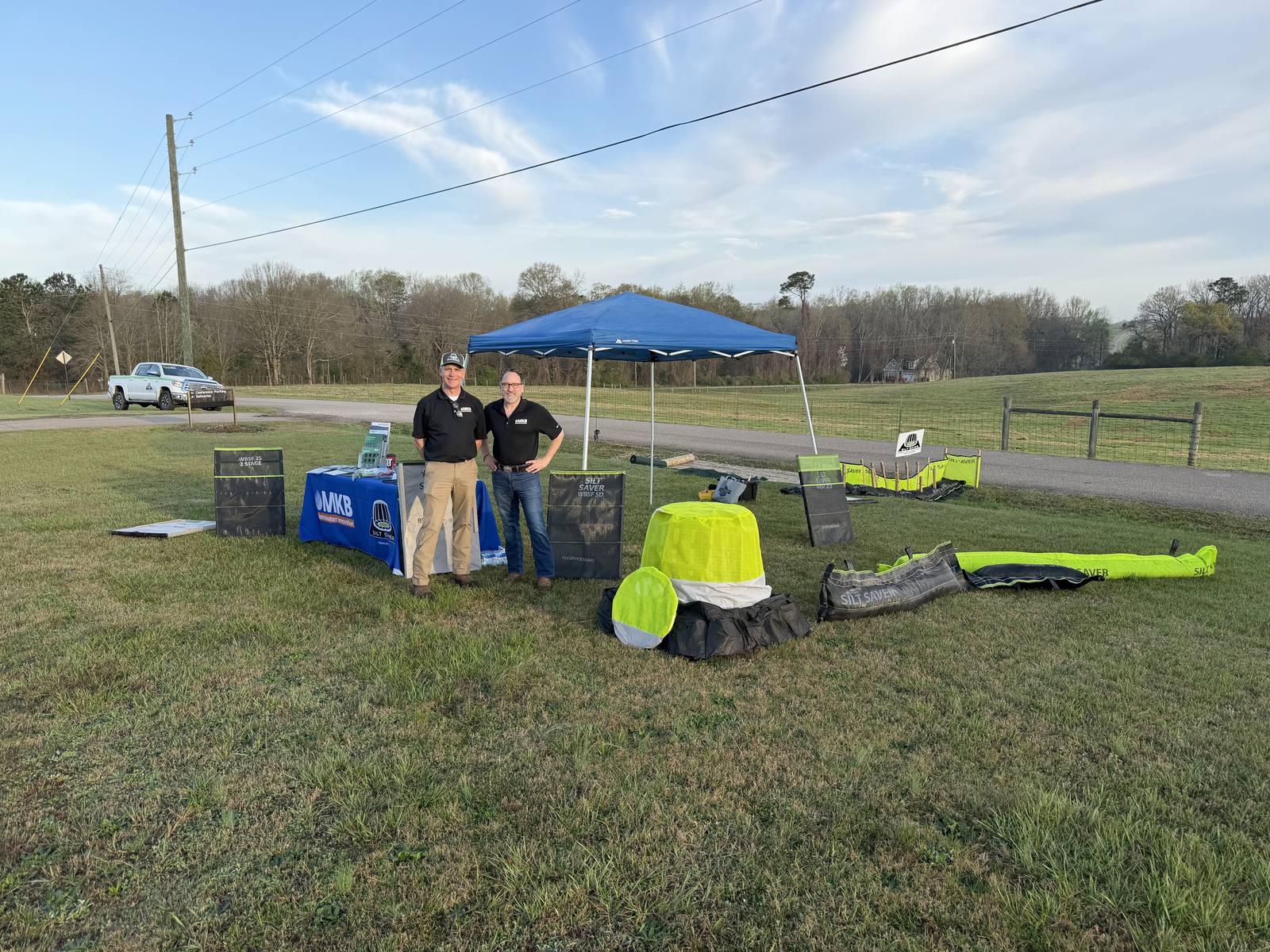 MKB staff at an outdoor product demonstration tent with sample products laid out